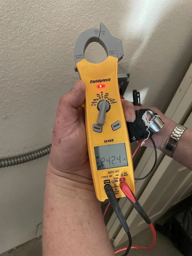 Voltage testing with clamp meter during Whole House Surge Protector in Camp Springs